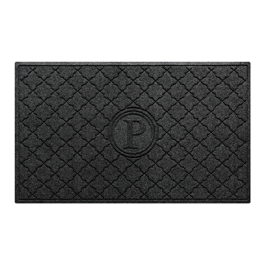 Isolated image of a large all-weather WaterHog Bombay Monogrammed Outdoor Doormat that features a classic repeating geometric pattern with an encircled letter placed in the center; shown in a dark charcoal color.