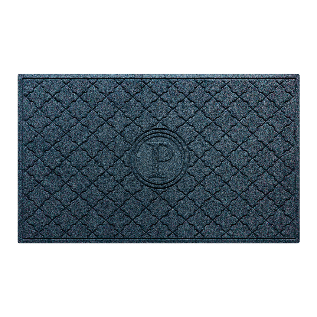 Isolated image of a large outdoor WaterHog Bombay Monogrammed Doormat that features a classic repeating geometric pattern with an encircled letter placed in the center; shown in a navy color.