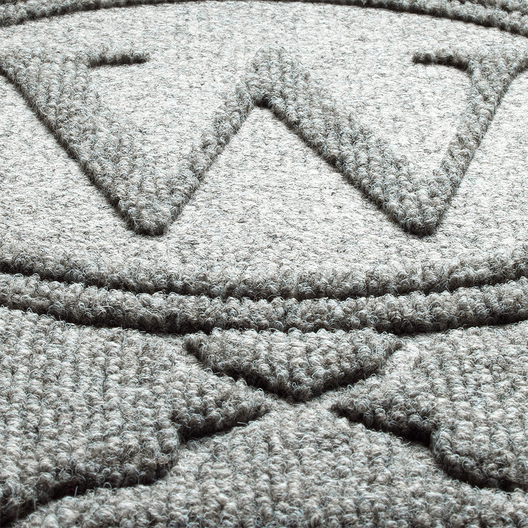 Close up image of WaterHog Bombay Monogrammed Doormat to showcase the bi-level design made from recycled PET fibers; shown in medium grey color.