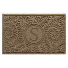 Overhead of a WaterHog Boxwood medium-sized monogram doormat in a light tan curling botanical, bi-level design.