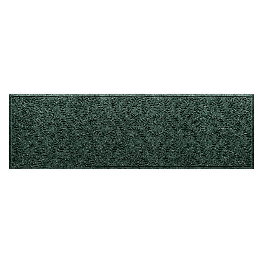 A genuine WaterHog medium-sized runner with a deep green curling botanical design.