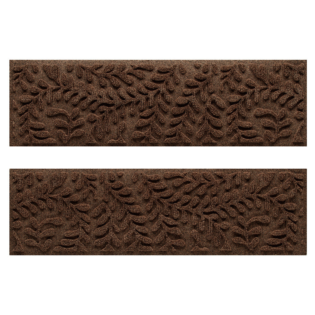 Two WaterHog indoor/outdoor stair treads in a dark earthy brown surface and curling botanical pattern.