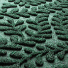 Close-up of the all-weather WaterHog fibers made of green, white, and grey creating a viney design from eco-friendly, fade-resistant fibers.