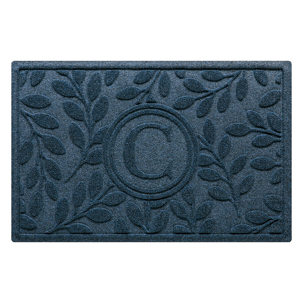 Deep blue genuine WaterHog doormat monogrammed with a letter in the center surrounded by a botanical leaf bi-level design perfect for scraping shoes and trapping moisture, dirt, and debris. 