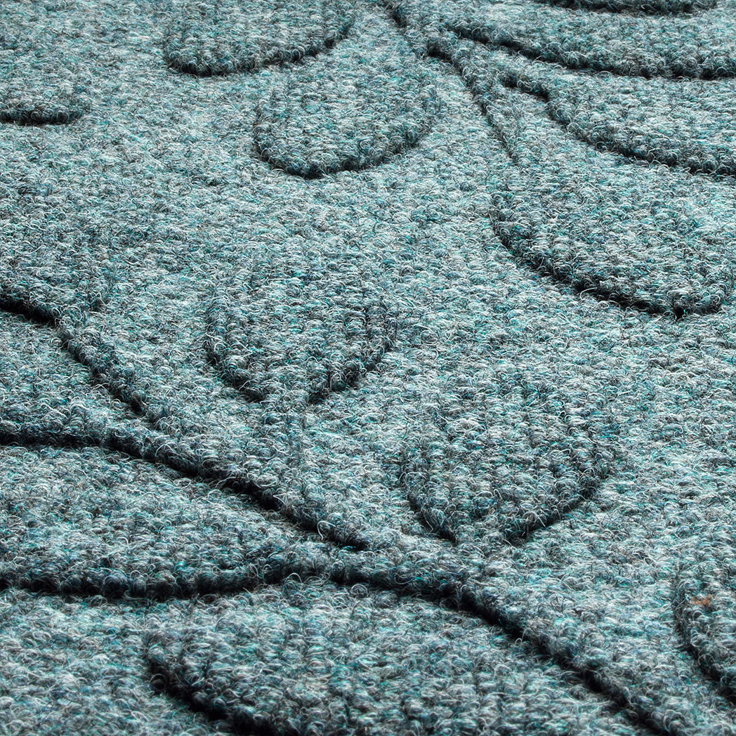 Close up of bluestone WaterHog surface PET fibers in blue, green, and gray. 