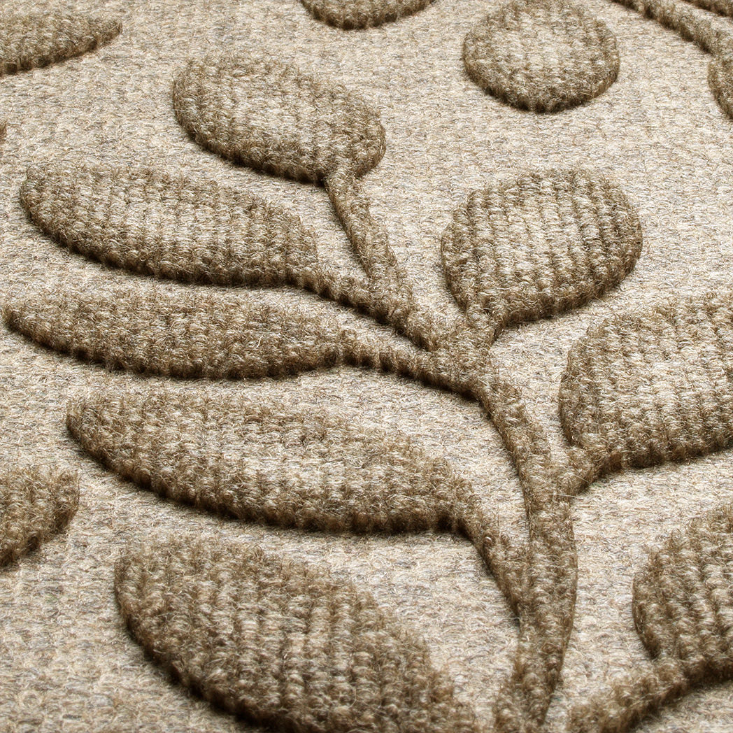 Up close photo of textured bi-level design made of tan/beige recycled PET fibers. 