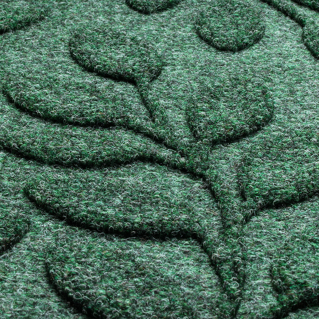 Close-up of recycled PET of WaterHog doormat detailing the bi-level surface with fibers in earthy green, gray, and black. 