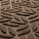 Detail shot of the stain-resistant WaterHog surface fibers made up of light and dark brown, white, and black fibers.