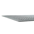 Side image of a very low-profile WaterHog mat in a medium-grey color with a textured fibrous surface and rubber packing to help prevent sliding. 