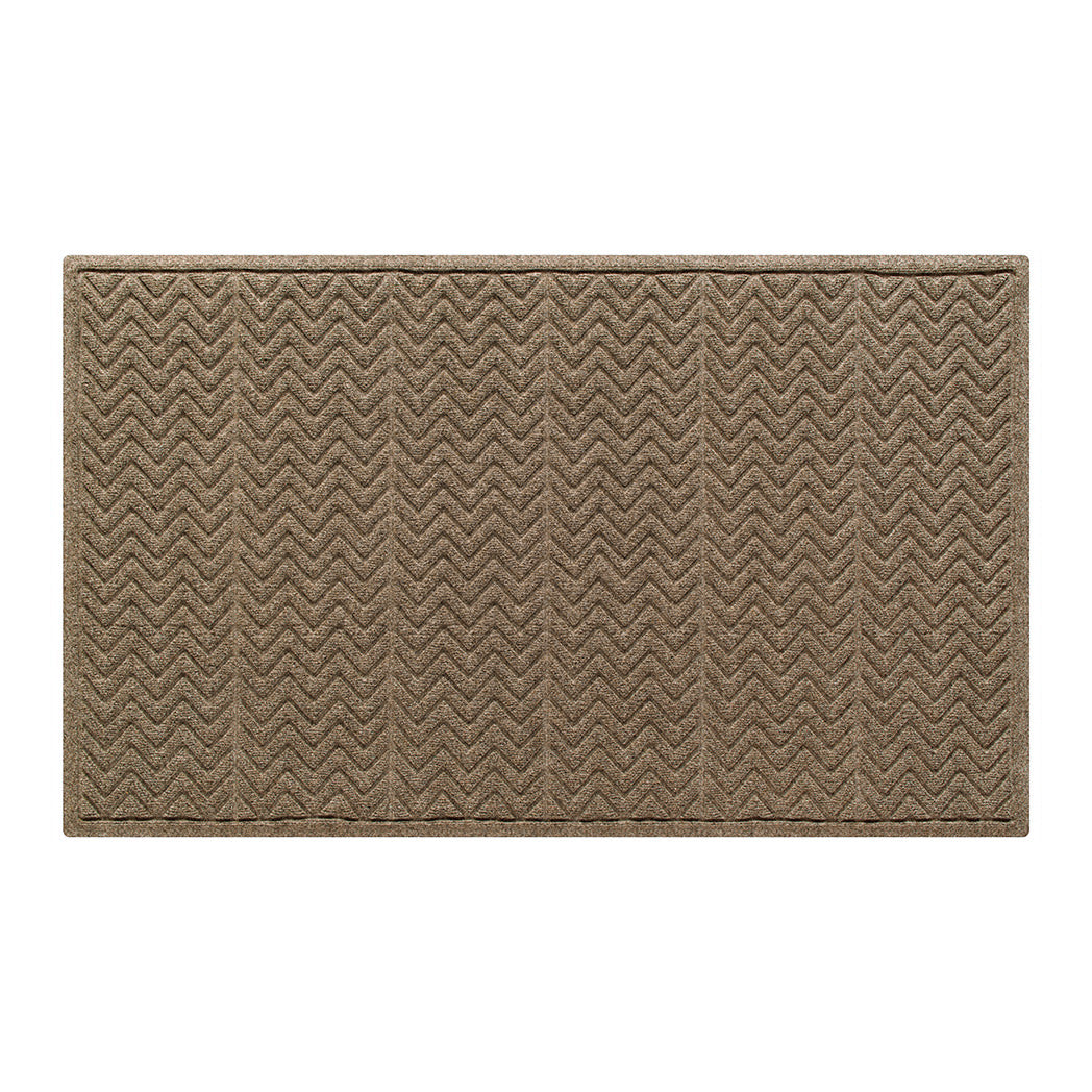 All-weather WaterHog doormat in a neutral brown or tan color with a bi-level zigzag or chevron pattern made of eco-friendly materials. 