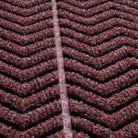 detailed photo of WaterHog chevron surface focusing on the bi-level design and PET fibers in colors red, black, and grey. 