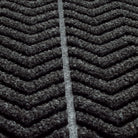 Zoomed in view of WaterHog Chevron doormat's surface detailing the bi-level recycled PET surface in fiber colors black and grey. 