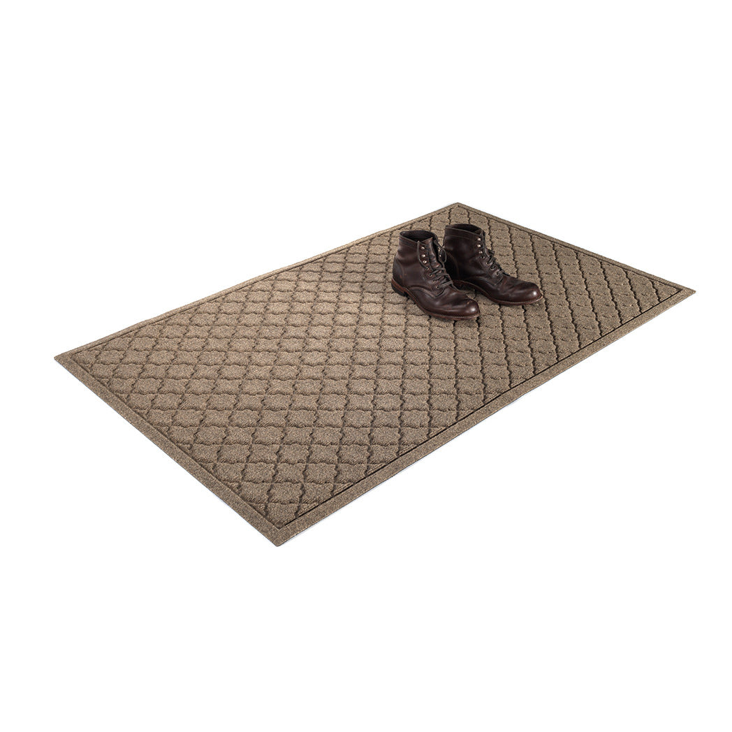WaterHog outdoor doormat in size 3x5 with a pair of dark brown boots sitting on top