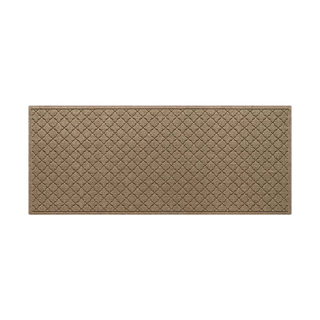 An OG WaterHog indoor/outdoor medium runner in a light tan repeating quatrefoil and eco-friendly, durable surface.