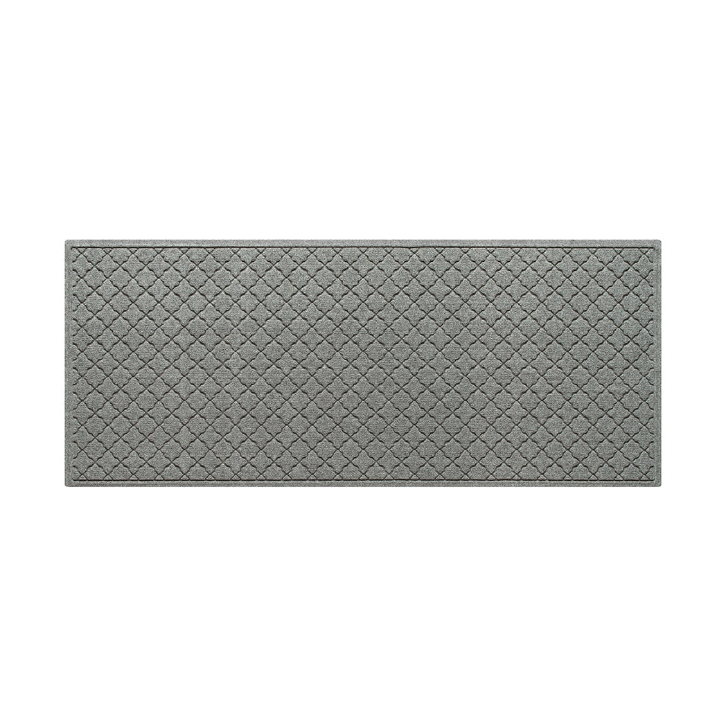 A WaterHog 3x7 indoor/outdoor luxury runner in a light grey surface and repeating quatrefoil pattern.