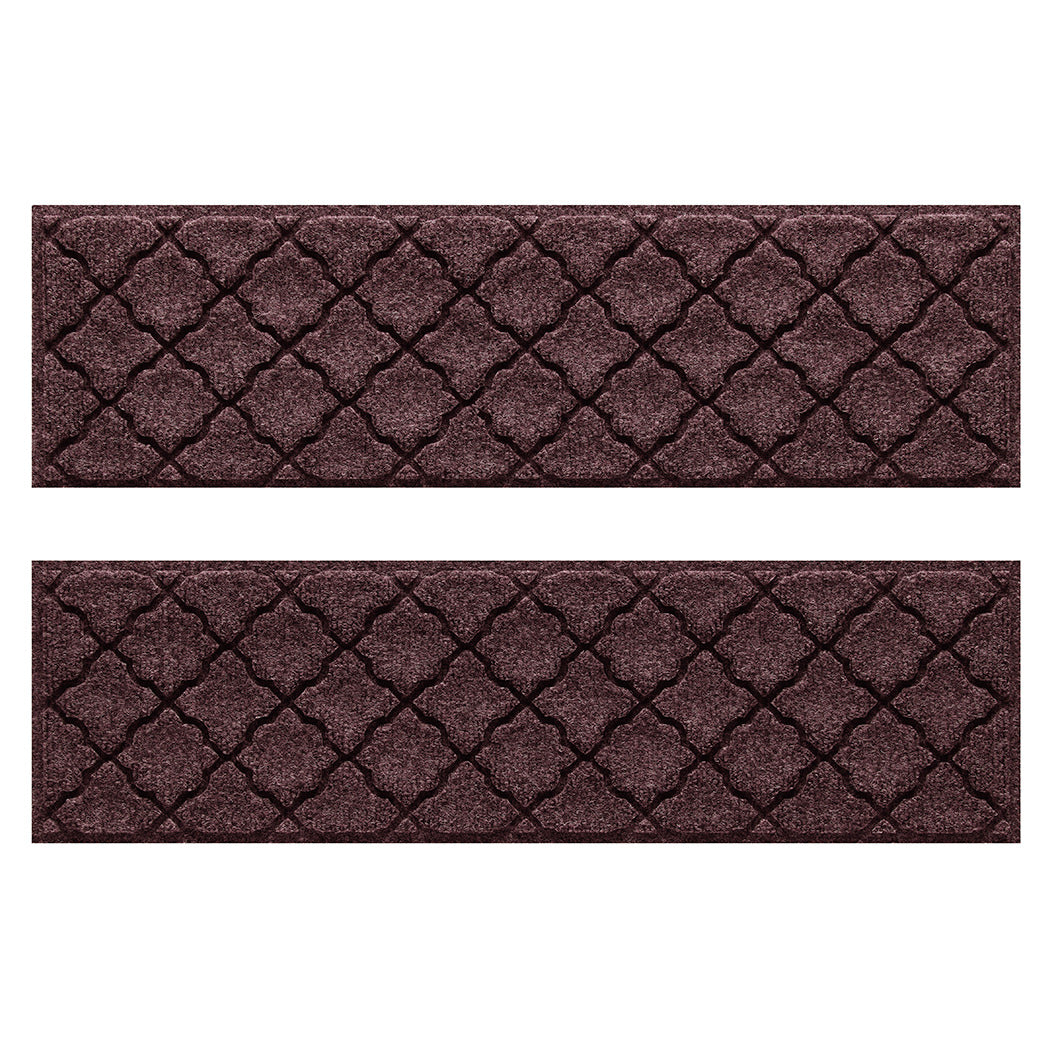 Two WaterHog Cordova water-resistant stair treads with a deep wine red repeating quatrefoil design.