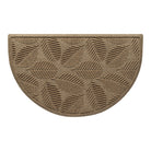 An OG WaterHog indoor/outdoor half-round doormat in a light tan leafy design, eco-friendly surface, and durable rubber backing.