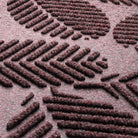 Close-up of the durable WaterHog fibers made of deep wine red, white, and grey fibers pressed to make an aesthetic design.