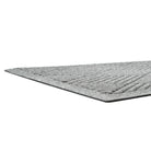 A low and close shot of Diamonds doormat's low-profile edge, bi-level surface, and rubber backing.