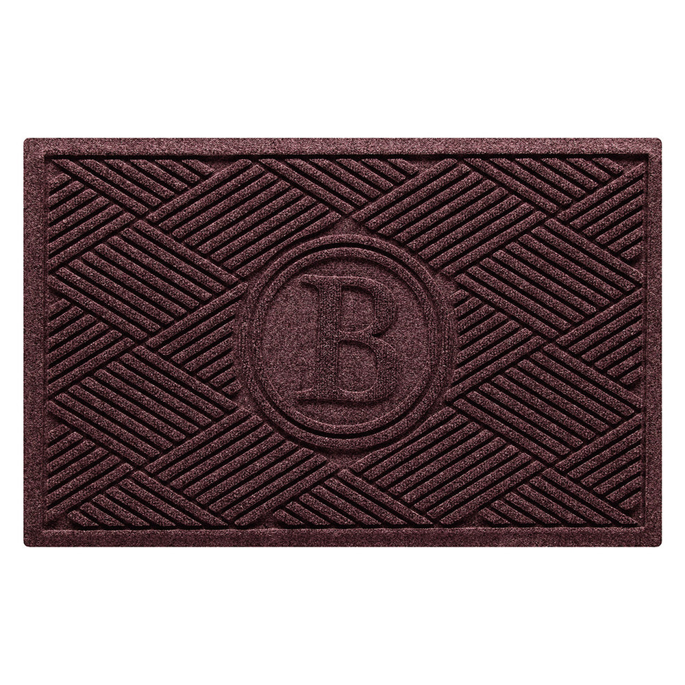 A monogrammed WaterHog all-weather doormat with a deep wine-red surface and crisscrossing linear pattern.