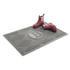 Isolated 2x3 WaterHog Diamonds monogrammed doormat in medium grey with a pair of brown leather boots.