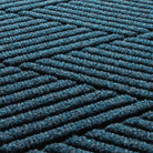 Detail image of the all-weather WaterHog durable surface made of dark and light blues, white and grey strands.