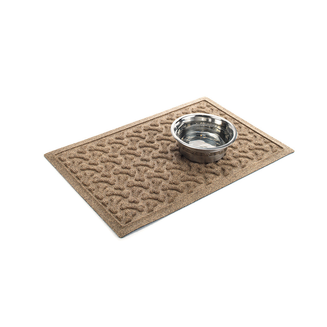 Angled Dog Bones bowl mat in camel with a water bowl on top all on a white background.