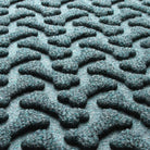 Detail shot of Dog Bone's eco-friendly surface, made of light blue, grey, and white fibers.