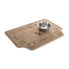 Angled WaterHog Drool Hog personalized bowl mat in 2x3 camel mat with a water dish and dog treats for size reference.