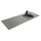 An outdoor WaterHog 2x5 luxury runner mat in light grey with a set of clean boots resting on top  on a white background.