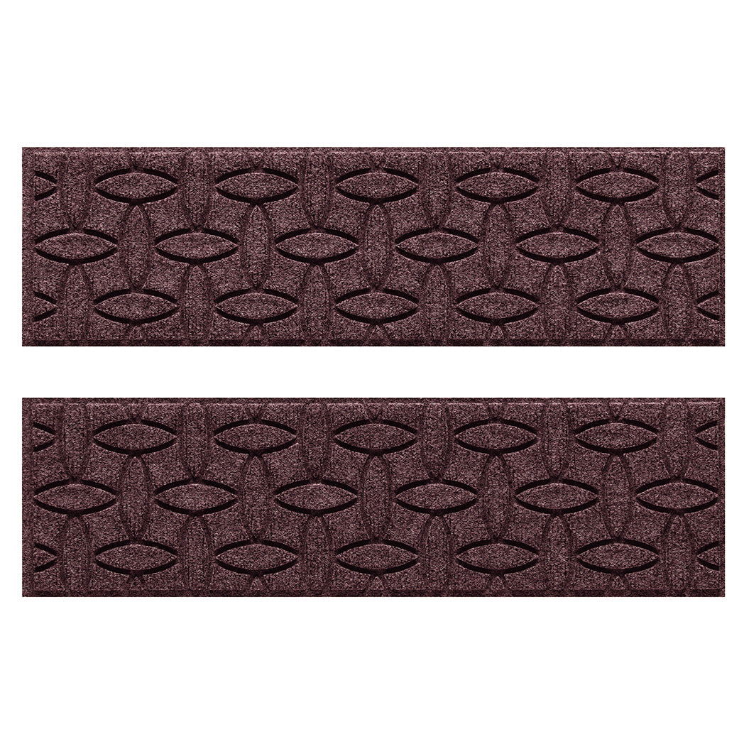 Two WaterHog Ellipse water-resistant stair treads with a deep wine red interlocking elliptical bi-level design.