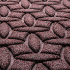 Close-up of Ellipse's surface fibers made of deep wine red, white, and grey fibers making an interlocking elliptical design.