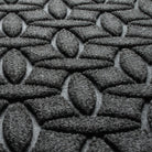 Close-up of WaterHog's Ellipse the eco-friendly fibers made of various shades of grey to black, with hints of white fibers.