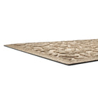 A low and close shot of a camel Fall Day's doormat's low-profile edge, bi-level surface, and rubber backing.