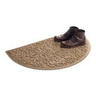 Isolated WaterHog Fall Day half-round doormat in camel with a pair of brown leather boots on the doormat.