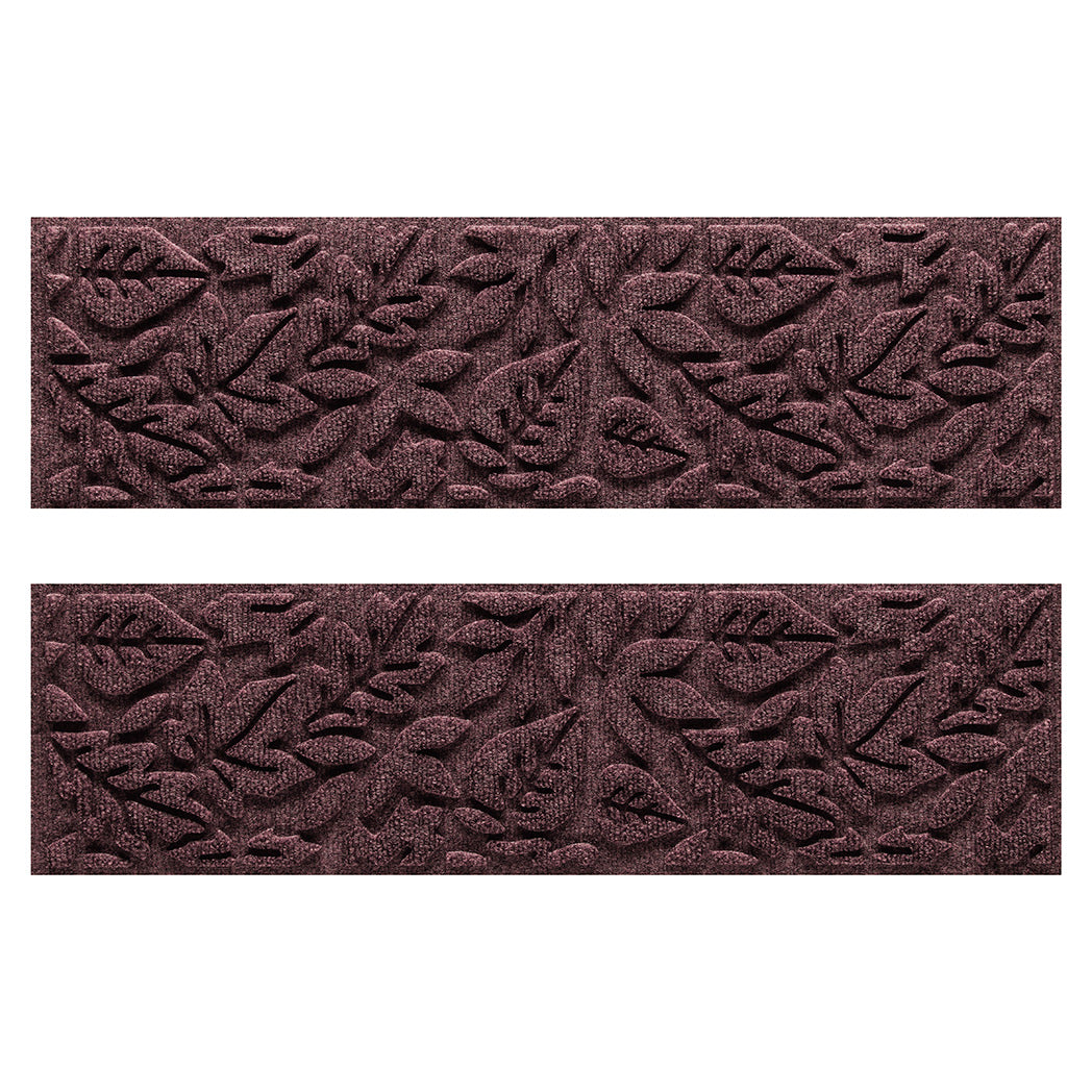 Two WaterHog Fall Day water-resistant stair treads with a deep wine red surface and fallen leaves pattern.