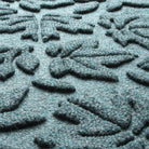 Detail shot of Fall Day's eco-friendly surface, made of light blue, grey, and white fibers.