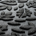 Close-up of WaterHog's the eco-friendly surface fibers made of various shades of grey to black that make up the carpeted surface of the mat.