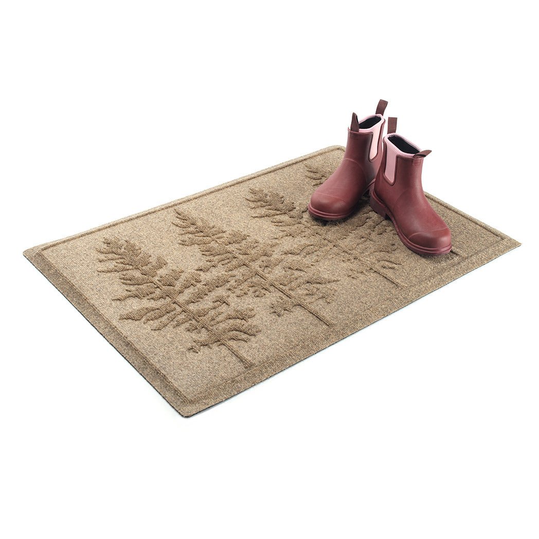 A WaterHog Fir Lineup indoor/outdoor mat in a tan color with a fir tree design.