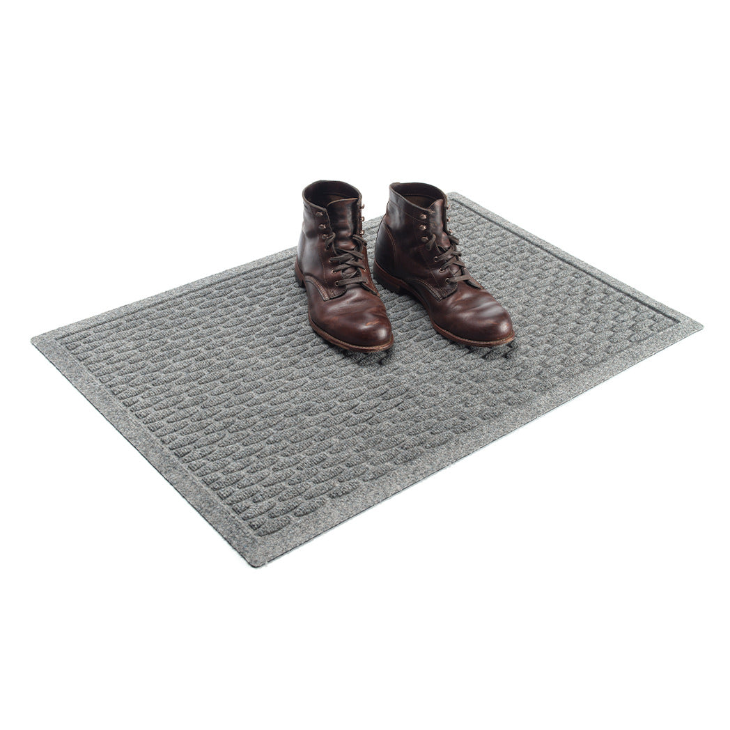 A 2x3 WateHog Hampton indoor/outdoor mat in a light grey color with a raised small oval sequence design.