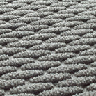 A close-up photo of the carpeted top of a WaterHog Hampton doormat displaying the bi-level scrapping surface.