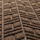 Detail shot of WaterHog's surface fibers made of light and dark brown, white, and black fibers pressed to make a cheveron-like design.