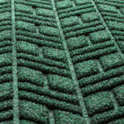 Close-up of High-Rise WaterHog door mat with fibers made of green, white, and grey creating a modern design.