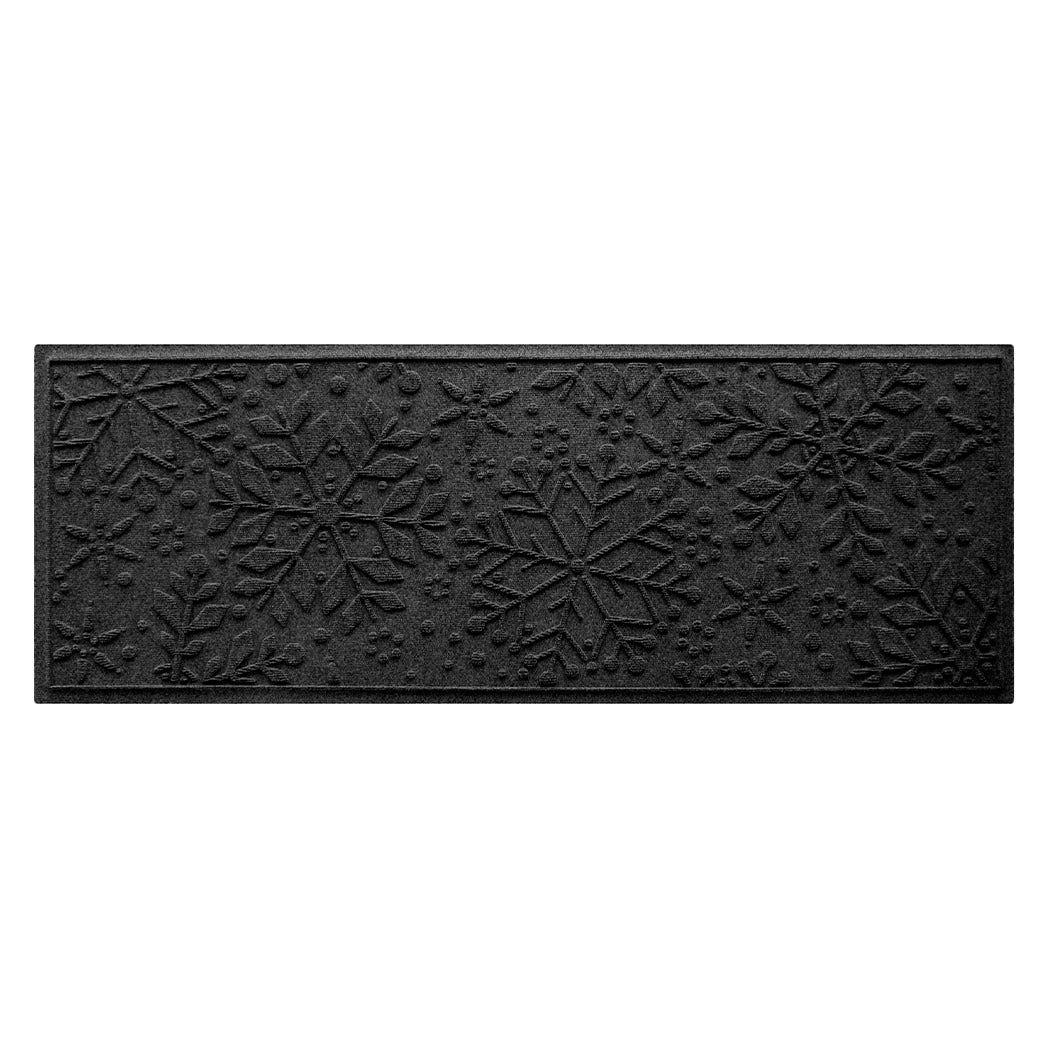 A deep, dark grey doormat with snowflake pattern on a white background