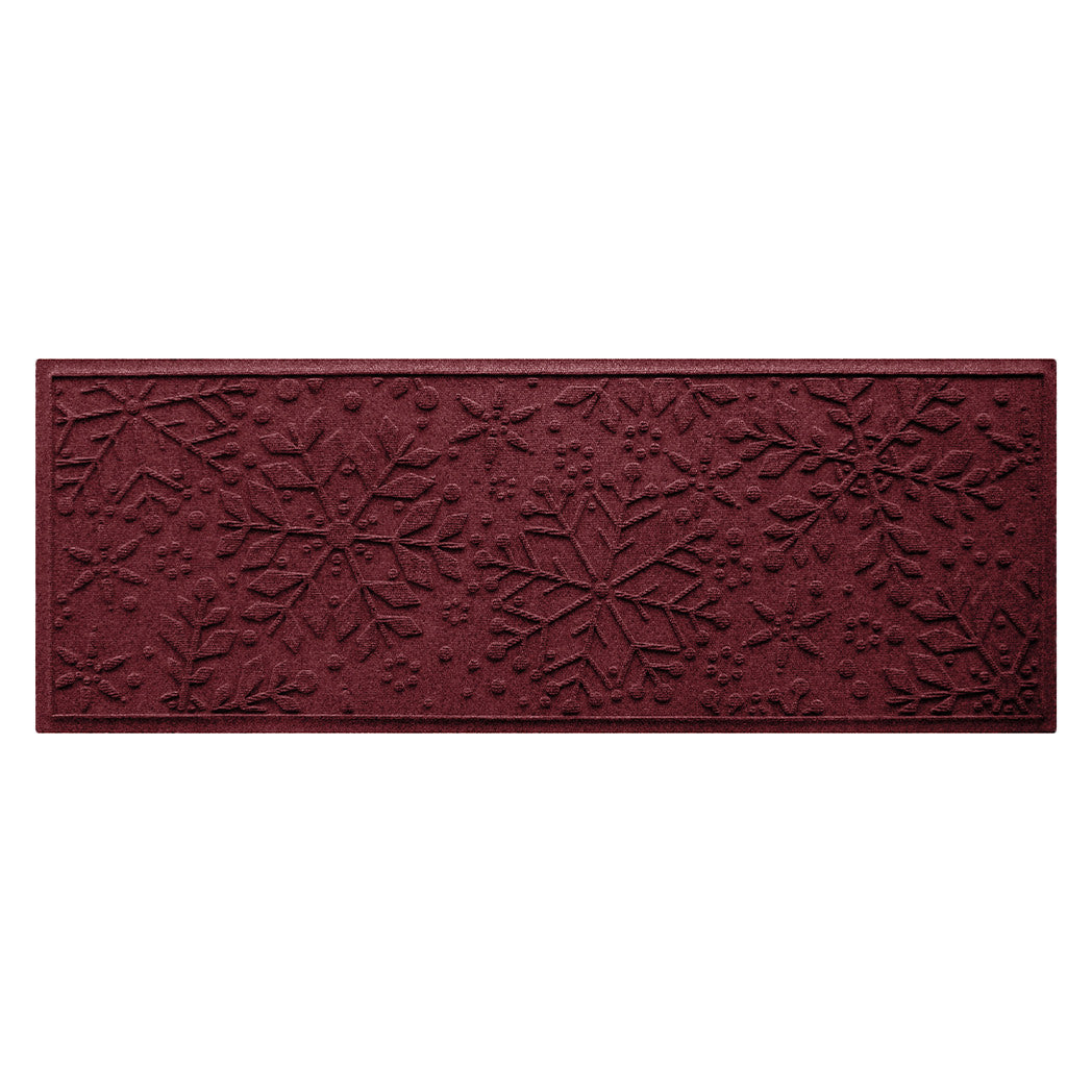 Dark cranberry red doormat runner with bi-level snowflake pattern on a white background