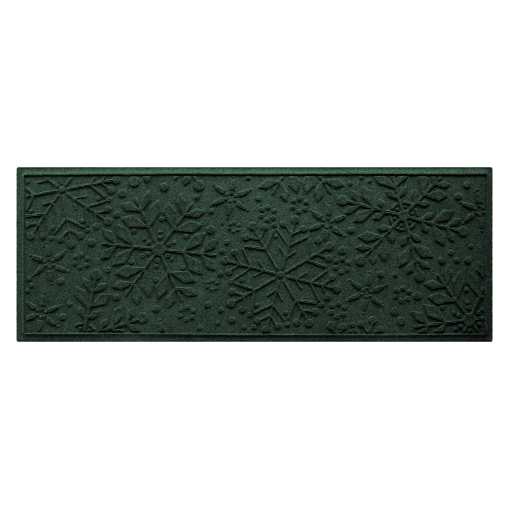 Deep green textured doormat with snowflake pattern on a white background