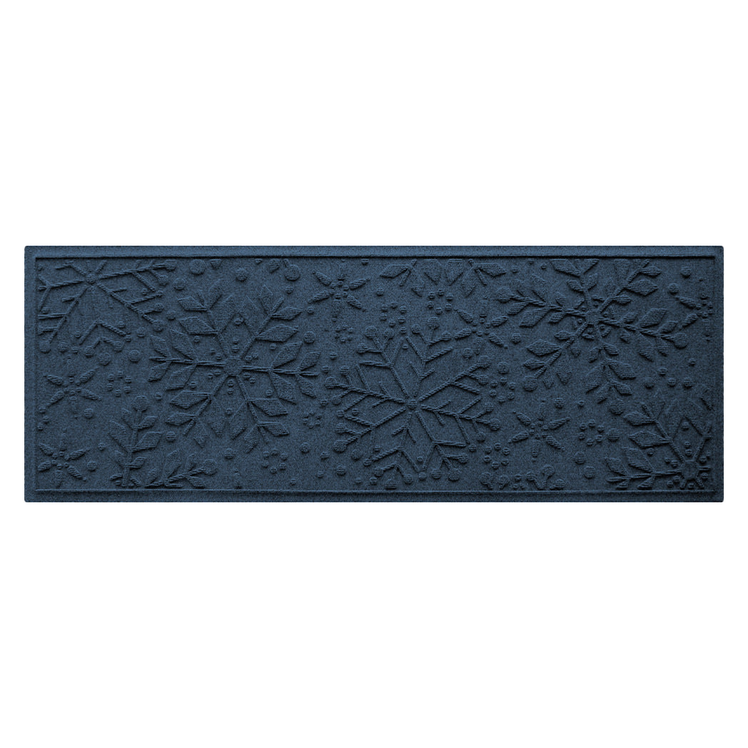 Navy blue doormat with snowflake pattern on a white background
