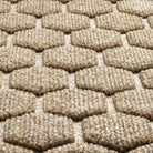 A close-up shot of the WaterHog Honeycomb all-weather doormat in tan, displaying the fibers that make up the raised design.