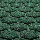 A close-up shot of the WaterHog Honeycomb durable doormat in deep green, displaying the carpeted fibers that form the raised design.