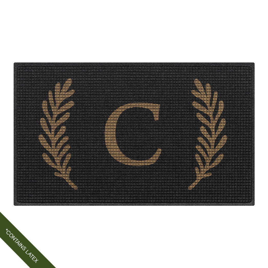 Large charcoal WaterHog Squares doormat personalized with a capitalized serif 'C' in tan with a laurel design; latex declaimer
